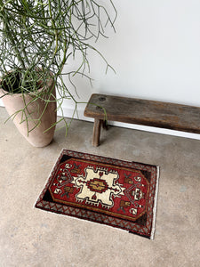 Red and brown Vintage Turkish rug on floor 