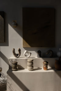 Styled shot of showroom, featuring sculptural ceramics and artwork.