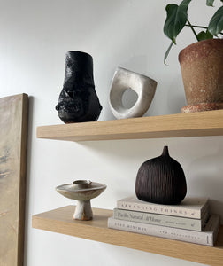 floating shelves styled with sculptural objects