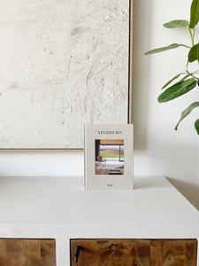 Book titled Studio Ko sitting on a white countertop
