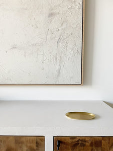 small brass oval tray on white countertop