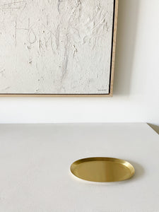 small brass oval tray on white countertop