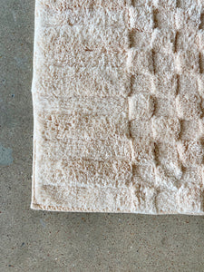 morrow clea bath mat light pink shaggy lying on cement floor