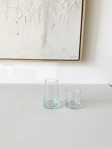 pair of recycled hawkins ny glasses one medium and one tall sitting on  a white counter top