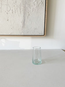 one tall recycled hawkins ny glass sitting on  a white counter top