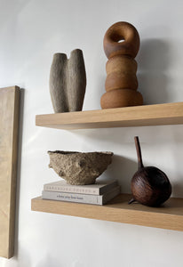 styled open shelving with ceramic sculptural objects and books