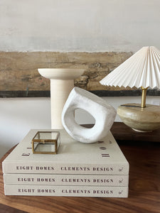 styled books, ceramics, and lamp display