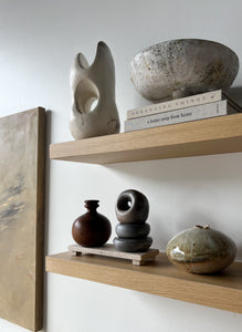 styled open shelving with ceramic sculptural items