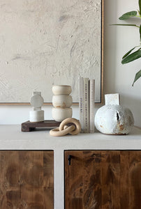 styled shot of ceramics and books in neutral colors.